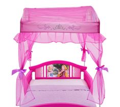 a pink princess canopy bed with pictures on the side and purple sheets over it, in front of a white background