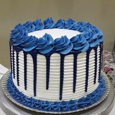 a blue and white cake with icing on it