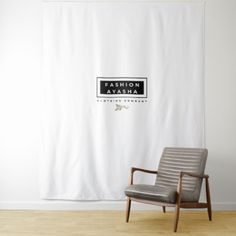 a chair sitting in front of a white curtain with the name fashion ayesha on it