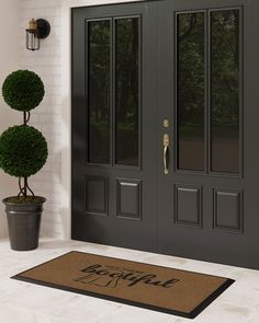 a door mat with the words bespiel on it next to a potted plant