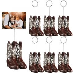 six pairs of cowboy boots hang from hooks with pictures attached to the handles, and an image of a woman holding a baby in her arms