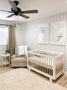 a baby's room with a white crib and beige furniture