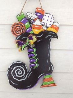 a halloween decoration hanging on the side of a building with candy and candies in it