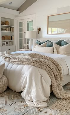 a large bed sitting in a bedroom next to a book shelf filled with lots of books