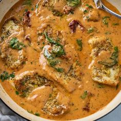 a pan filled with meat and vegetables covered in gravy on top of a table