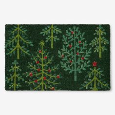 a green door mat with christmas trees on it and red berries all over the edges