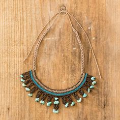 Really talented artisans can made amazing jewelry from the most simple of materials. Costa Rican artisans Marielos and Tania demonstrate what their gifted hands can do with this intricately-woven waterfall style necklace made of brown beige and dark teal cords with reconstituted turquoise accents. Blue Macrame, Macrame Necklaces, Waterfall Necklace, Gifted Hands, Turquoise Accents, Costa Rican, Brown And Blue, Necklace Turquoise, Macrame Necklace