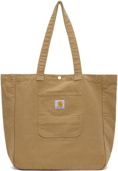 Washed 12 oz organic cotton canvas tote in brown. · Twin shoulder straps · Logo patch at patch pocket · Press-stud closure · Zip pocket at interior · Logo-engraved gold-tone hardware · H15 x W15.75 x D5 / 19.8 L Supplier color: Peanut Brown Cotton Canvas Bag With Pockets, Glam Slam, Interior Logo, Micro Bag, Sophie Bille Brahe, Carhartt Work In Progress, Clutch Pouch, Medium Tote, Work In Progress