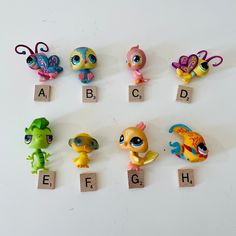 there are many little toy animals that are on the pegs to spell out letters