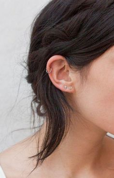 a close up of a person with ear piercings