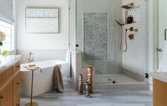 a bathroom with a walk in shower next to a bath tub