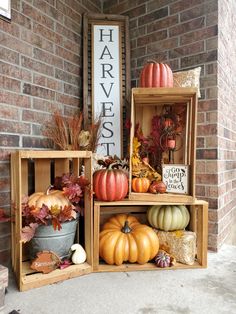 three wooden crates filled with pumpkins and gourds next to a sign that says harvest