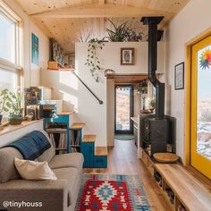 a living room filled with furniture and a wood burning stove top oven next to a window