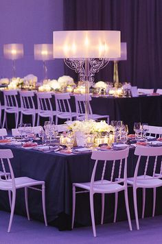 the tables are set up with candles and place settings for an elegant dinner party or special event