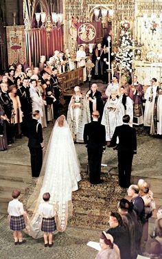 an old photo of a wedding ceremony with the bride and groom walking down the aisle