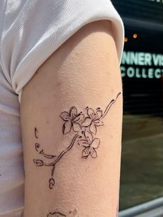 Cherry blossom sakura tattoo Sakura Collar Bone Tattoo, Cherry Blossom Arm Band Tattoo, Sakura Cherry Blossom Tattoo, Cute Cherry Blossom Tattoo, Red Sakura Tattoo, Cherry Blossom Finger Tattoo, Fine Line Tattoo Cherry Blossom, Single Cherry Blossom Tattoo, Sakura Tattoo Black And White