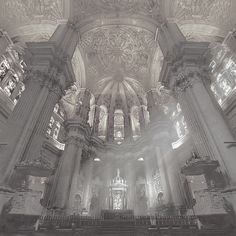 the interior of an old church with pews and stained glass windows in black and white