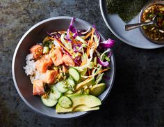 two bowls filled with different types of food on top of a stone table next to another bowl