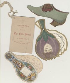 an assortment of antique items including shoes, paper tags and other decorative items are on display