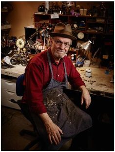 a man sitting in a chair with an apron on