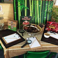 a table topped with lots of books and other items next to a bowl of food