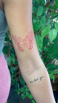 a woman's arm with a butterfly tattoo on the left side of her arm