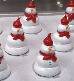 a group of snowmen with hats and scarfs