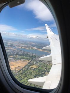 the view from an airplane window looking out on farmland