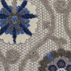 an image of a blue and grey pattern on fabric or carpeting material with flowers