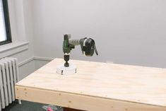 a drill is sitting on top of a piece of plywood