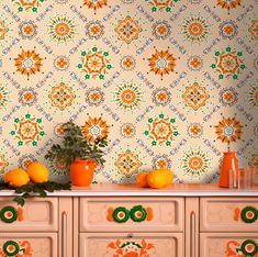 an orange vase sitting on top of a dresser