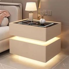 a night stand with two drawers and a lamp on the end table next to it