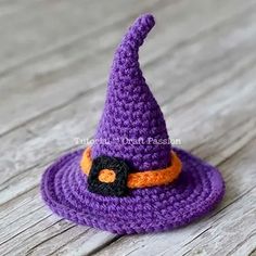 a purple crocheted witch hat with an orange and black patch on the top