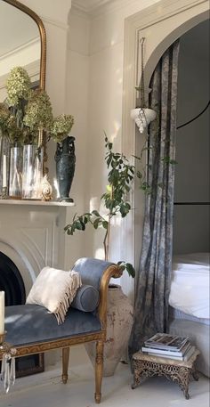 a living room filled with furniture and a fire place in front of a mirror on the wall