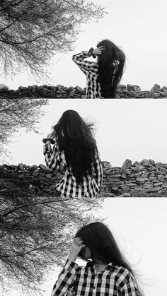 a woman with long hair standing next to a tree