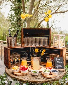 a wooden table topped with cups filled with drinks