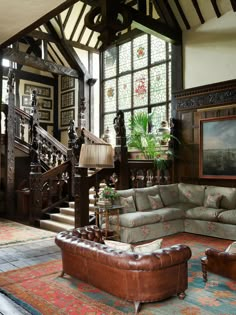 a living room filled with furniture and lots of windows