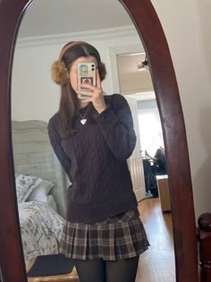 girl wearing brown earmuffs and brown cableknit sweater with a brown plaid skirt Grunge Coquette Winter Outfits, Fall Outfits Skirt Aesthetic, Coquette Fall Outfits Aesthetic, Winter Outfits Skirt Aesthetic, Brown Earmuffs Outfit, Winter Fashion Coquette, Coquette Style Outfits Winter, Coquette Fits Winter, Autumn Outfit Inspo Aesthetic