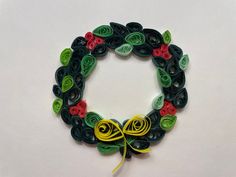 a wreath made out of buttons and paper