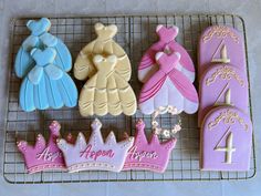 decorated cookies on a cooling rack with the number four and tiara for princesses