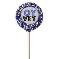 a blue and white lollipop with the words oy vey on it