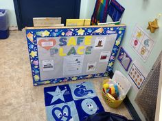 a child's play area with toys and posters on the wall, including a blue door mat that says safe place