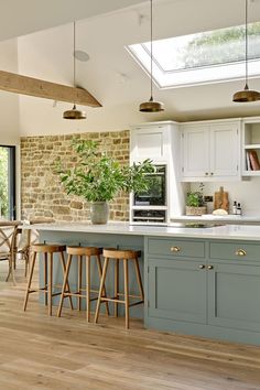 a kitchen with wooden floors and blue cabinets