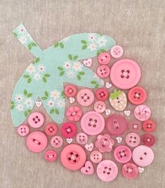 buttons are arranged in the shape of an umbrella on a piece of fabric with flowers and leaves