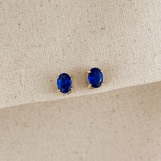 These elegant stud earrings feature stunning oval-cut cubic zirconia stones in a rich sapphire blue hue. The classic oval shape of the stones adds a touch of sophistication, while the brilliant blue color catches the eye and complements a variety of skin tones. These versatile studs are perfect for both everyday wear and special occasions, adding a pop of color and sparkle to any outfit. The secure post backing ensures comfort and stability throughout the day. Whether worn alone for a subtle sta Hand Chain Bracelet, 18k Gold Chain, Cubic Zirconia Necklace, Cz Stud Earrings, Emerald Jewelry, Anklet Jewelry, Sapphire Blue, Earrings Collection, Cuff Bangles