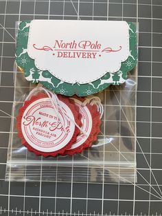 some cookies are wrapped in plastic and sitting on a cutting board next to a ruler