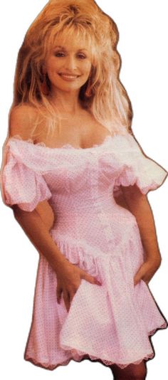 a woman in a pink dress posing for the camera with her hands on her hips