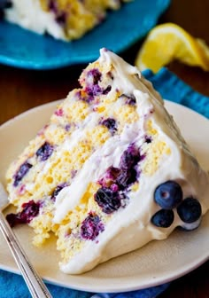 a slice of lemon blueberry cake on a plate with a fork next to it