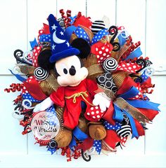 a mickey mouse wreath with red, white and blue decorations