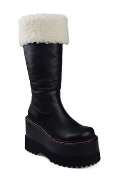 A bold update on a classic boot, this version is trimmed in plush faux fur and sits atop a towering platform heel. 4 1/2" heel 14" shaft; 14" calf circumference Pull-on style Water resistant Leather and textile faux-fur upper/leather lining/rubber sole Imported Platform Boots Women, Classic Boots, Platform Heel, Platform Boots, Fur Trim, Platform Heels, Boot Shoes Women, Rubber Sole